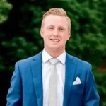 Kevin Jarrett, Sales Manager at Fire Monitoring of Canada, wearing a blue suit and white tie.
